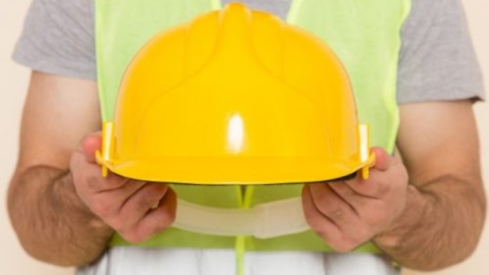 front-view-male-builder-taking-off-yellow-helmet-light-background_140725-27038-e1617203892802