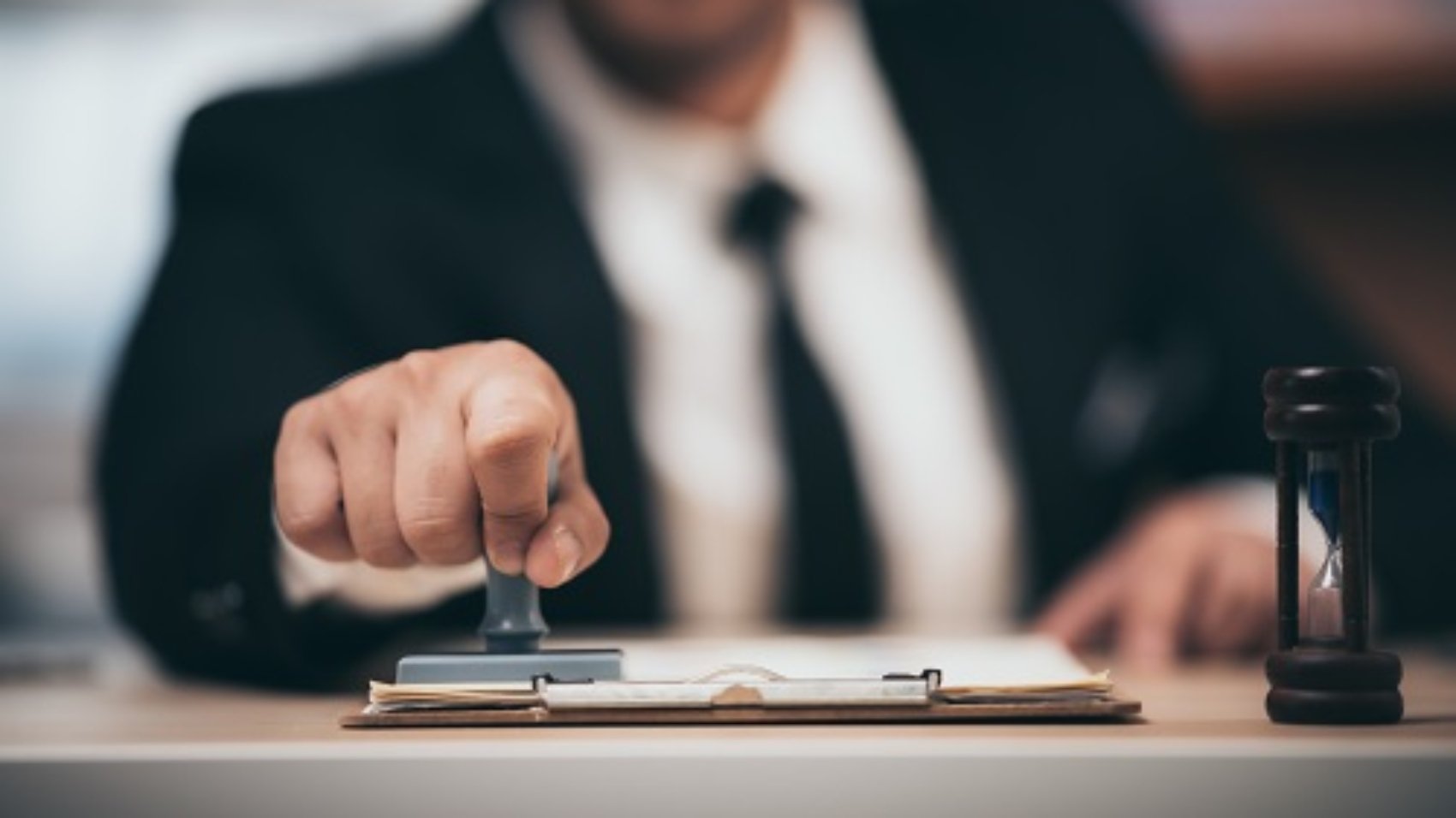 Young business man appoval stamper stamp on paper business contract, loan money approved.